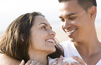 smiling couple look at each other